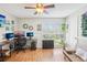 Comfortable home office with wood floors, two computer setups, and a view of the yard at 9481 Highland Oak Dr # 1616, Tampa, FL 33647