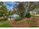 Scenic pond featuring a fountain and colorful flower beds, creating a serene outdoor setting at 9481 Highland Oak Dr # 1616, Tampa, FL 33647