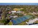 Aerial view showcasing tennis courts, baseball field, and recreational facilities within a residential neighborhood at 1000 79Th N Ave # 211, St Petersburg, FL 33702