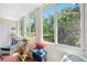 Sunroom with large windows provides natural light and views of the surrounding landscape at 1000 79Th N Ave # 211, St Petersburg, FL 33702