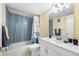 The bathroom features a blue tiled shower, a white vanity, and modern fixtures at 1000 79Th N Ave # 211, St Petersburg, FL 33702