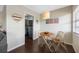 Cozy dining area with a round table, two chairs, and an art decor piece near the entrance to the kitchen at 1000 79Th N Ave # 211, St Petersburg, FL 33702