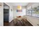 Bright dining area with a round table, two chairs, and a stainless steel refrigerator nearby at 1000 79Th N Ave # 211, St Petersburg, FL 33702