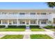 Well-maintained condo exterior with neat landscaping and uniform architectural details at 1000 79Th N Ave # 211, St Petersburg, FL 33702