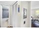 Hallway with a closet and a view into the bathroom with blue tiles in the shower at 1000 79Th N Ave # 211, St Petersburg, FL 33702
