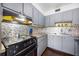 This kitchen has matching grey cabinets and stainless steel appliances at 1000 79Th N Ave # 211, St Petersburg, FL 33702