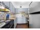 Functional kitchen featuring modern appliances and mosaic backsplash at 1000 79Th N Ave # 211, St Petersburg, FL 33702