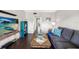 Spacious living room with hardwood floors, sofa, and entertainment center at 1000 79Th N Ave # 211, St Petersburg, FL 33702