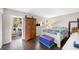Bright main bedroom boasts hardwood floors, a private balcony, and neutral color scheme at 1000 79Th N Ave # 211, St Petersburg, FL 33702