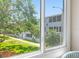 This view looks out to a well-maintained lawn and surrounding greenery at 1000 79Th N Ave # 211, St Petersburg, FL 33702