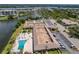 Bird's eye view featuring a community pool and parking lot near a tranquil pond at 10035 63Rd N Ave # 23, St Petersburg, FL 33708