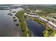 Aerial view of condos surrounded by lush greenery, walking path, and a serene body of water at 10035 63Rd N Ave # 23, St Petersburg, FL 33708