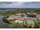 Expansive overhead view featuring a pool, tennis courts, buildings, and a waterway at 10035 63Rd N Ave # 23, St Petersburg, FL 33708