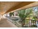 Exterior balcony view with railing overlooking a well-manicured lawn and landscaping offering a serene outdoor retreat at 10035 63Rd N Ave # 23, St Petersburg, FL 33708