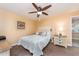 Comfortable bedroom features a ceiling fan, neutral colors, and a queen-size bed with stylish bedding at 10035 63Rd N Ave # 23, St Petersburg, FL 33708