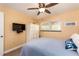 Relaxing bedroom with ceiling fan, window for natural light, and comfortable blue bedding at 10035 63Rd N Ave # 23, St Petersburg, FL 33708