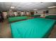 Large community game room with multiple pool tables, ping pong table, and foosball at 10035 63Rd N Ave # 23, St Petersburg, FL 33708
