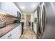 Efficient kitchen with white cabinets, modern appliances, attractive backsplash, and durable countertops for a functional design at 10035 63Rd N Ave # 23, St Petersburg, FL 33708