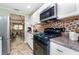 Updated kitchen with white cabinets, stainless steel appliances, mosaic backsplash and easy access to the living area at 10035 63Rd N Ave # 23, St Petersburg, FL 33708