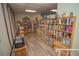 Community library with rows of books, cozy seating, and natural light from the window at 10035 63Rd N Ave # 23, St Petersburg, FL 33708