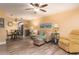Inviting living room with wood-look flooring, neutral-toned furniture, ceiling fan and an adjacent dining area at 10035 63Rd N Ave # 23, St Petersburg, FL 33708