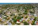 Aerial view of a neighborhood with mature trees, streets, homes, and proximity to the ocean at 10074 Bahama Ct, Seminole, FL 33776