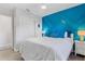 Bedroom featuring decorative blue accent wall, new ceiling fan and closet at 10074 Bahama Ct, Seminole, FL 33776