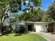 Inviting front exterior with well-manicured lawn and attached garage at 10074 Bahama Ct, Seminole, FL 33776