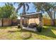 Backyard gazebo with comfortable seating, flower pots, and privacy curtains creating a relaxing outdoor space at 10074 Bahama Ct, Seminole, FL 33776