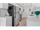 Bright, modern kitchen with stainless steel appliances, white cabinets, and elegant countertops at 10074 Bahama Ct, Seminole, FL 33776