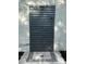 Outdoor shower with modern fixtures and privacy surround at 10074 Bahama Ct, Seminole, FL 33776