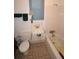 Functional bathroom featuring a toilet, sink, tile accents, and a tub with a shower at 1107 S Prospect Ave, Clearwater, FL 33756