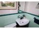 Charming bathroom featuring tile accents, sink, toilet, and framed artwork at 1107 S Prospect Ave, Clearwater, FL 33756