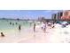 A vibrant beach scene with people enjoying the sun and clear water on a sunny day at 1107 S Prospect Ave, Clearwater, FL 33756