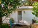 Inviting home featuring a charming entrance with lush landscaping around the exterior at 1107 S Prospect Ave, Clearwater, FL 33756