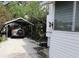 Charming home exterior features a covered parking area and landscaped surroundings at 1107 S Prospect Ave, Clearwater, FL 33756