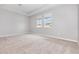 Spacious bedroom with plush carpeting and two windows for natural light at 11638 Woodleaf Dr, Bradenton, FL 34211