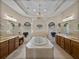 Spacious bathroom features a jetted tub, dual sinks, vanities, and a chandelier at 13538 Thoroughbred Dr, Dade City, FL 33525