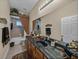 Bathroom with a long vanity, decorative mirror, tiled walls and a tub with shower at 13538 Thoroughbred Dr, Dade City, FL 33525