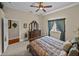 Spacious bedroom with large window, dark wood furniture and a doorway to another room at 13538 Thoroughbred Dr, Dade City, FL 33525