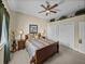 Comfortable bedroom featuring a ceiling fan, a queen bed, and built-in display shelving at 13538 Thoroughbred Dr, Dade City, FL 33525