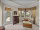 Bedroom with sitting area with a view of pool and access to the screened lanai at 13538 Thoroughbred Dr, Dade City, FL 33525
