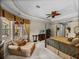 Bedroom with sitting area, tray ceiling, views of screened lanai and pool at 13538 Thoroughbred Dr, Dade City, FL 33525
