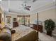 Bedroom boasts a four-poster bed and views of the screened lanai and pool at 13538 Thoroughbred Dr, Dade City, FL 33525