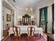 Dining room with hardwood floors, chandelier, traditional furniture, and natural light at 13538 Thoroughbred Dr, Dade City, FL 33525