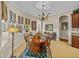 Elegant dining room features a chandelier, a round table and decorative window treatments at 13538 Thoroughbred Dr, Dade City, FL 33525
