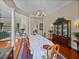 Charming dining room with hardwood floors, chandelier, and traditional furniture, open to the living spaces at 13538 Thoroughbred Dr, Dade City, FL 33525