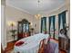 Elegant dining room featuring a chandelier, hardwood floors, china cabinet, and views to the exterior at 13538 Thoroughbred Dr, Dade City, FL 33525