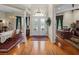 Bright foyer with double doors, chandelier, and hardwood floors leading to dining and office spaces at 13538 Thoroughbred Dr, Dade City, FL 33525