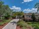 Charming single-story home with well-manicured landscaping and a brick driveway at 13538 Thoroughbred Dr, Dade City, FL 33525